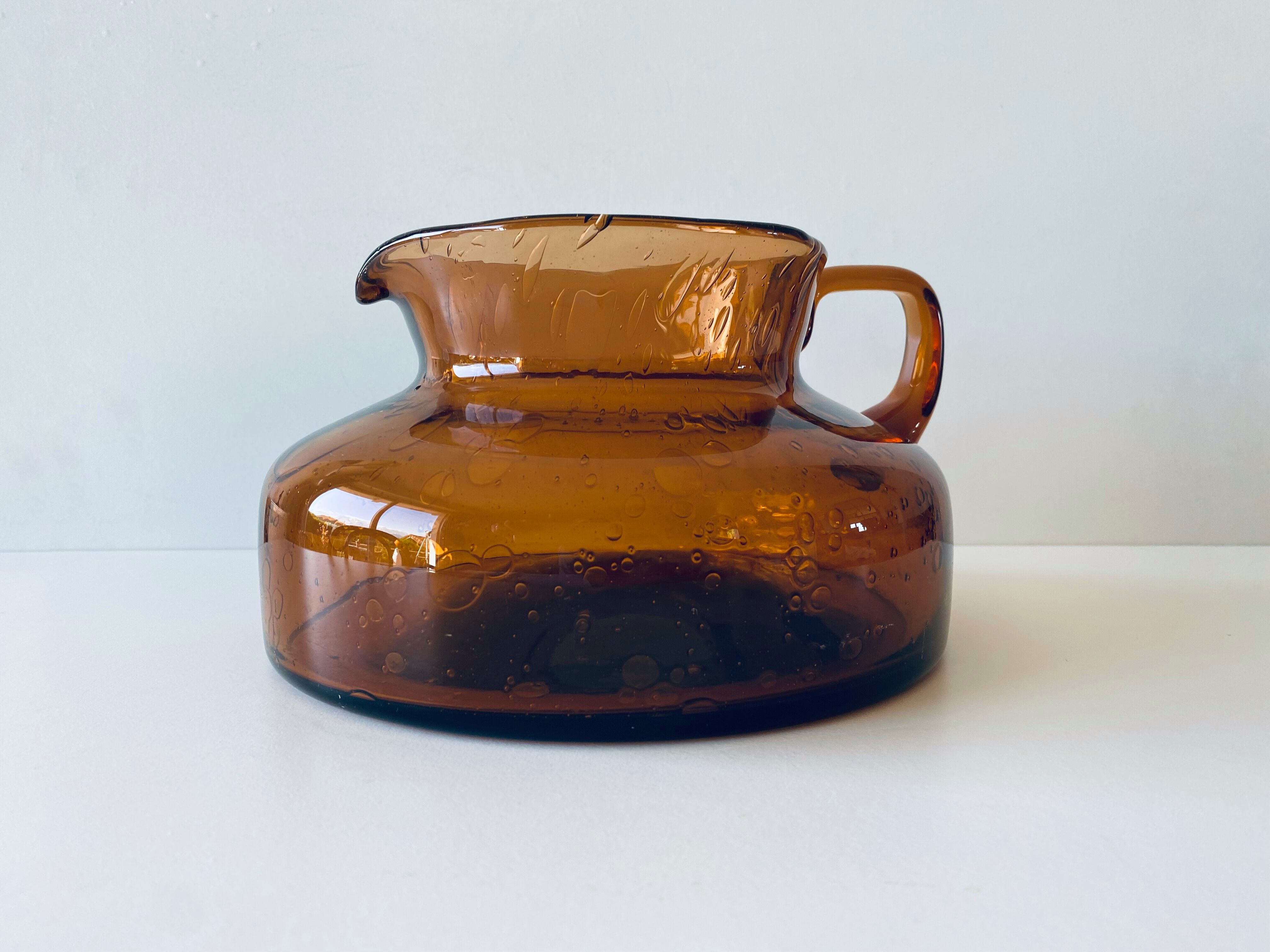 Decanter made of blown and bubbled amber glass