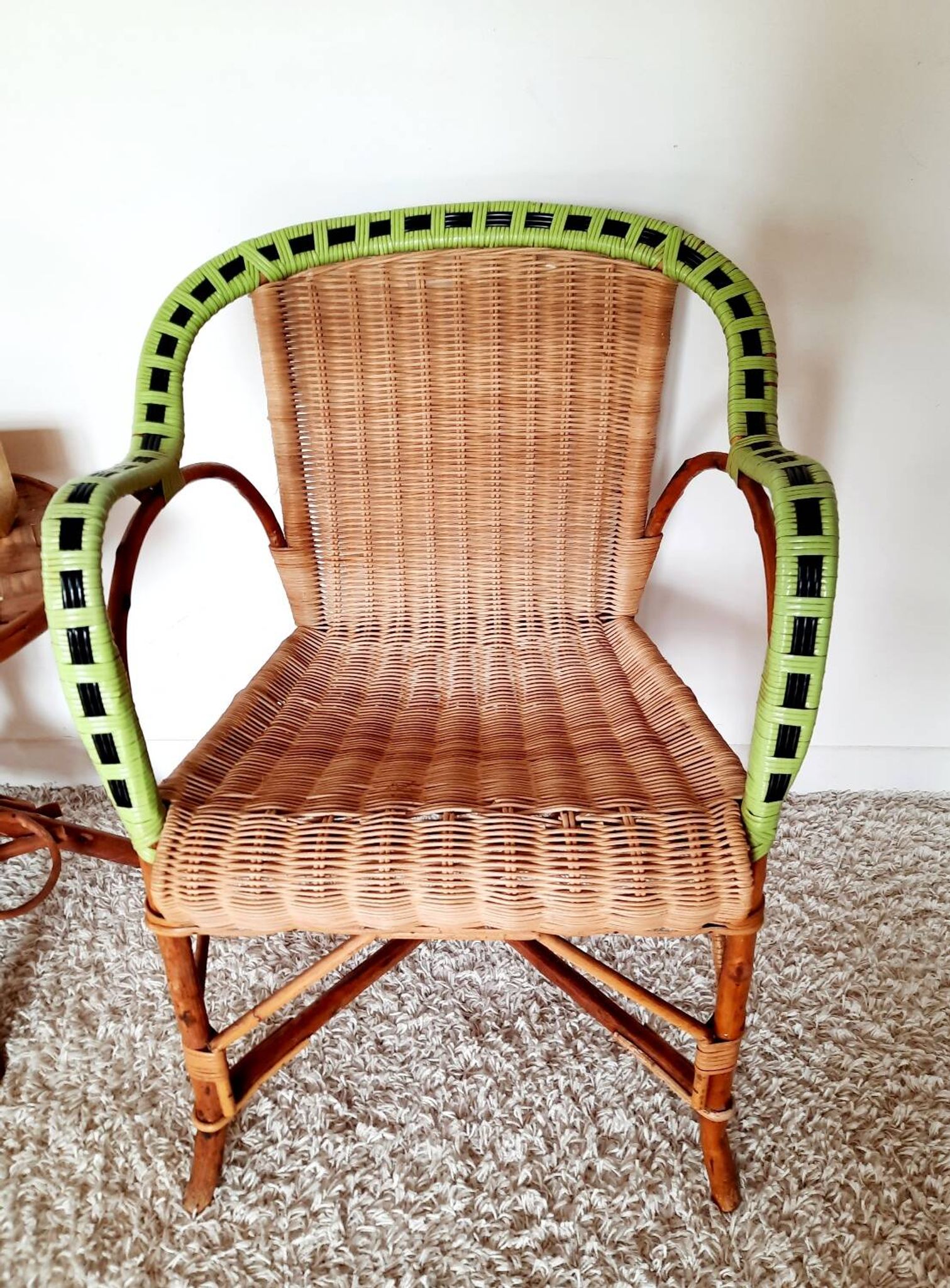 1950s 60s rattan armchair with green apple and black piping.