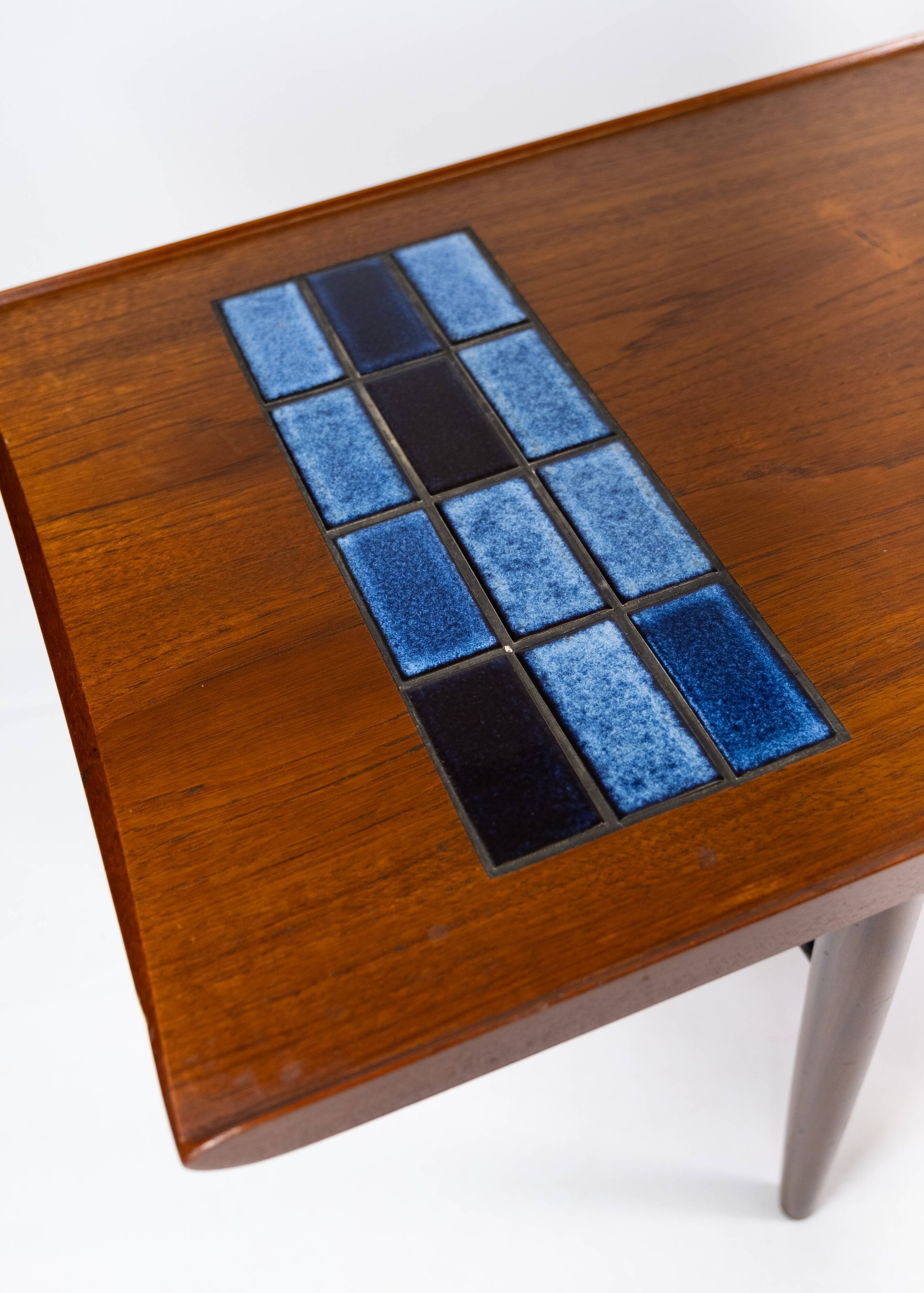Coffee table in teak with blue tiles of danish design from the 1960s.