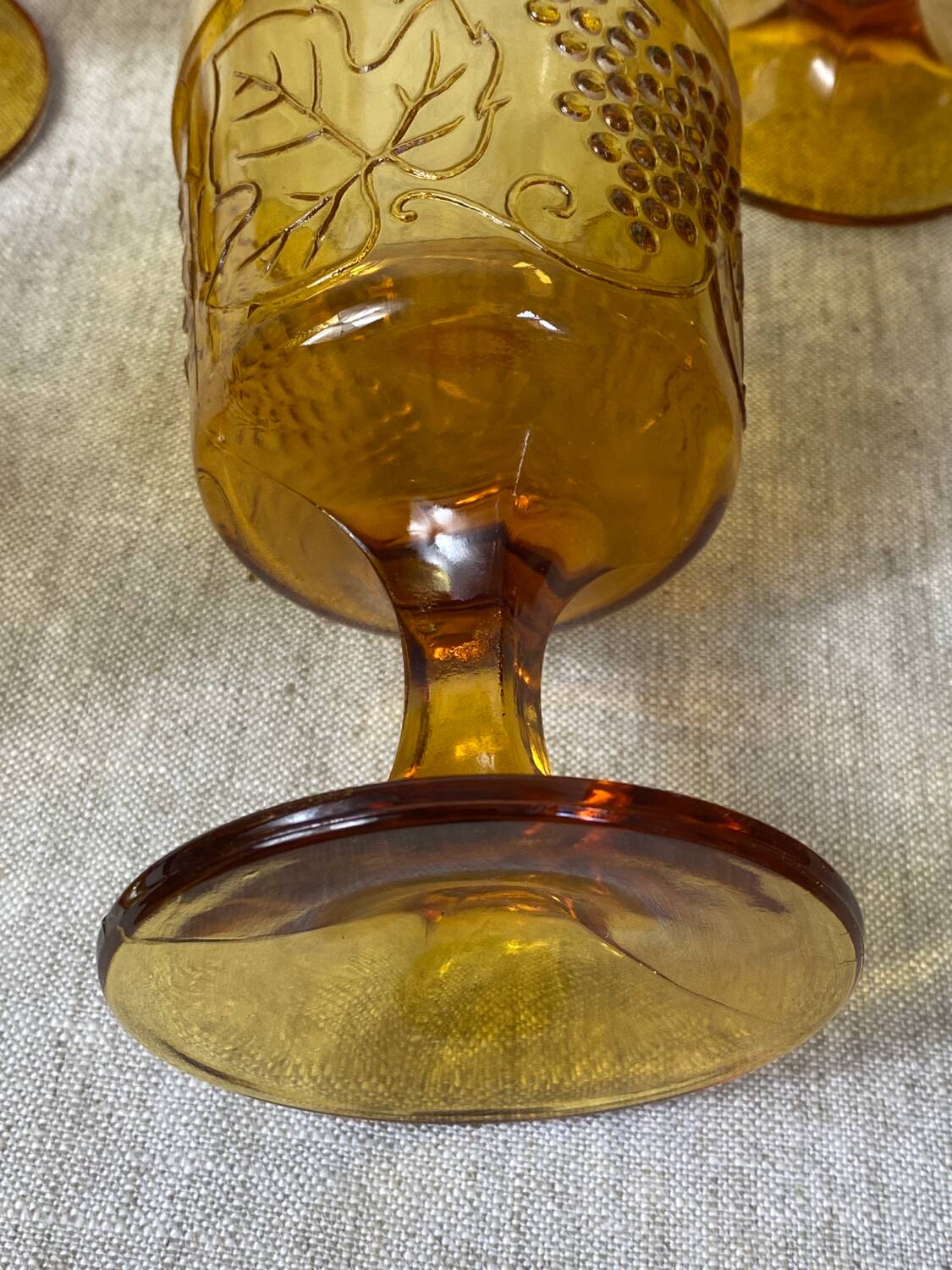 Six amber-colored stemmed glasses