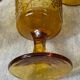 Six amber-colored stemmed glasses