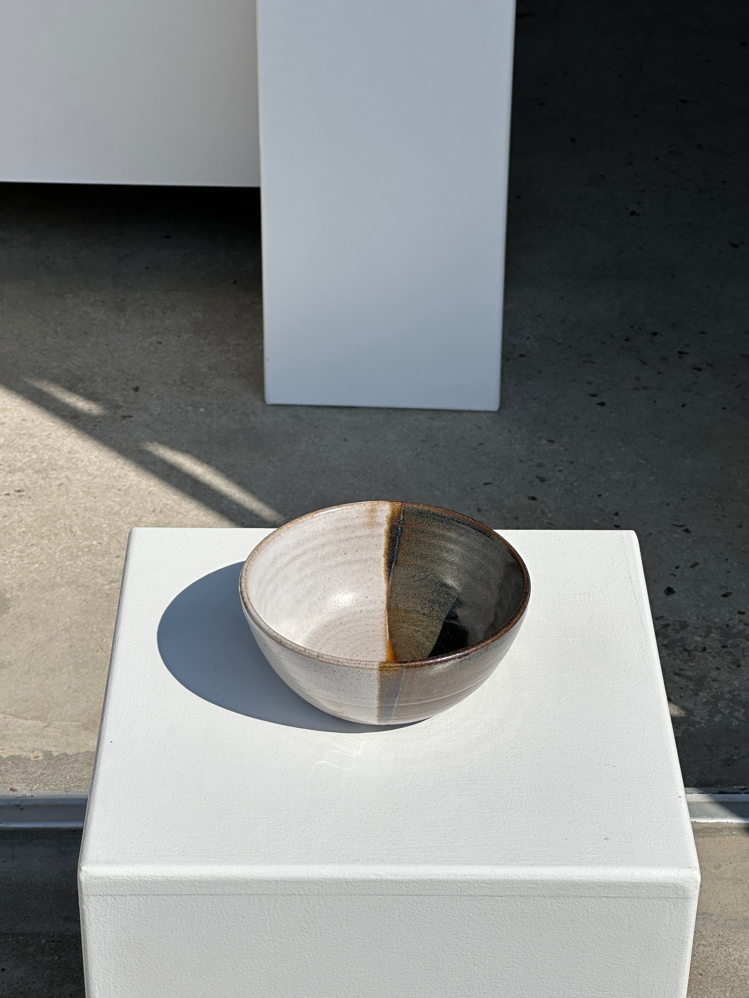 White and glossy brown two-tone ceramic bowl, matt earth