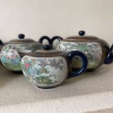 CHINA, 20th century Part of a porcelain tea service with polychrome decoration of palace scenes and v