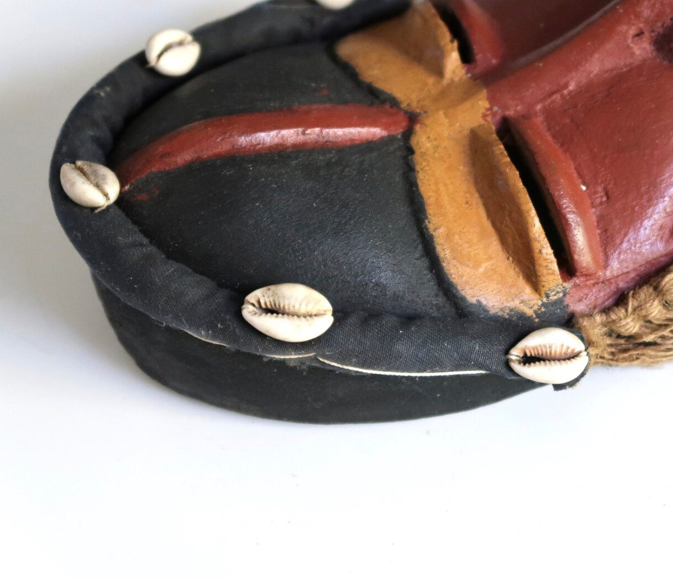 African wooden mask with shells and rope