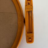 Tilting orange plastic mirror with its matching wall light