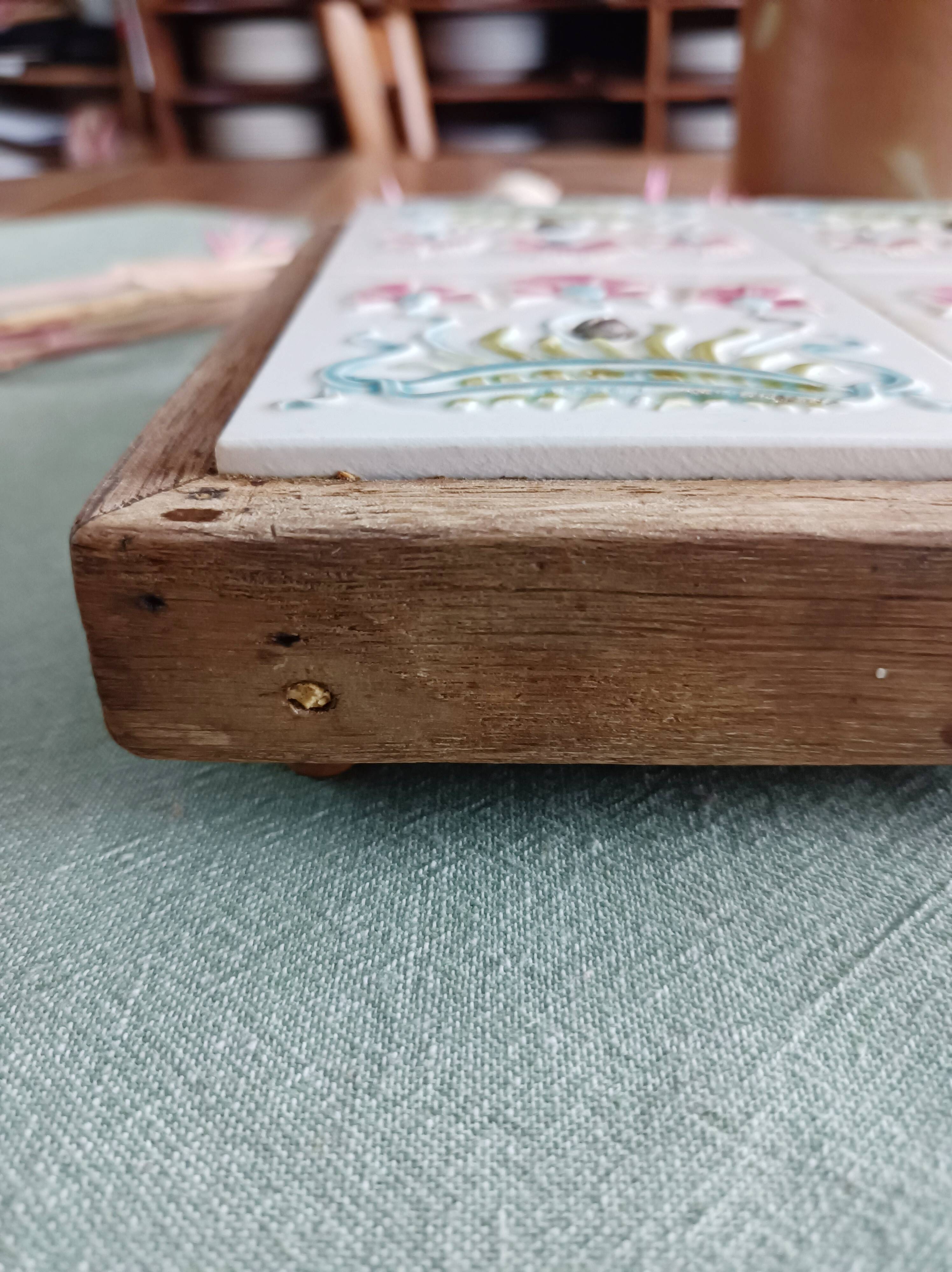 Antique earthenware and wood trivet