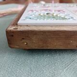 Antique earthenware and wood trivet