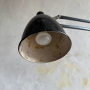 Vintage industrial articulated desk lamp in black metal with cast-iron base, adjustable arm
