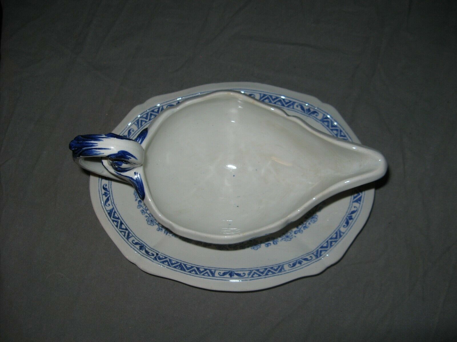 Saucière in Gien earthenware anse in the shape of a dolphin decoration garland 1900