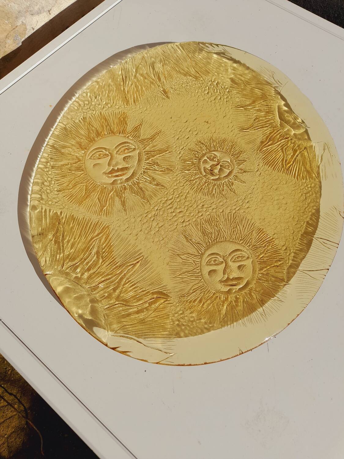 Glass plate decorated with suns, 1980.