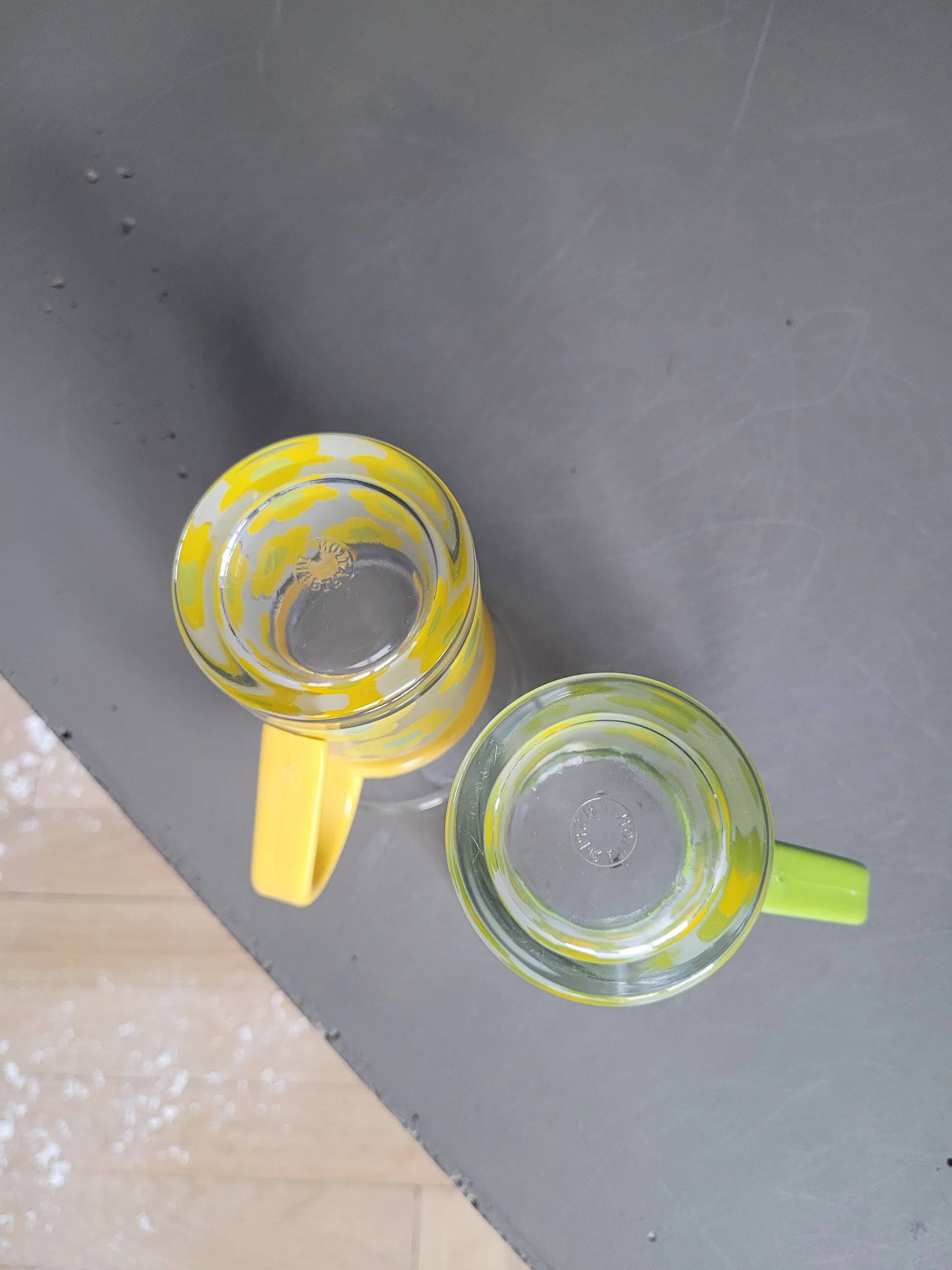 Pair of glass teacups with plastic handles