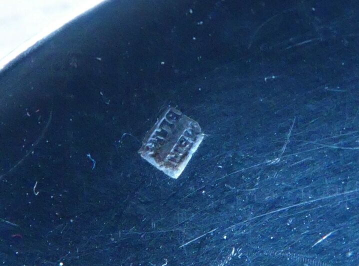 2 small white metal spoons