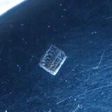 2 small white metal spoons