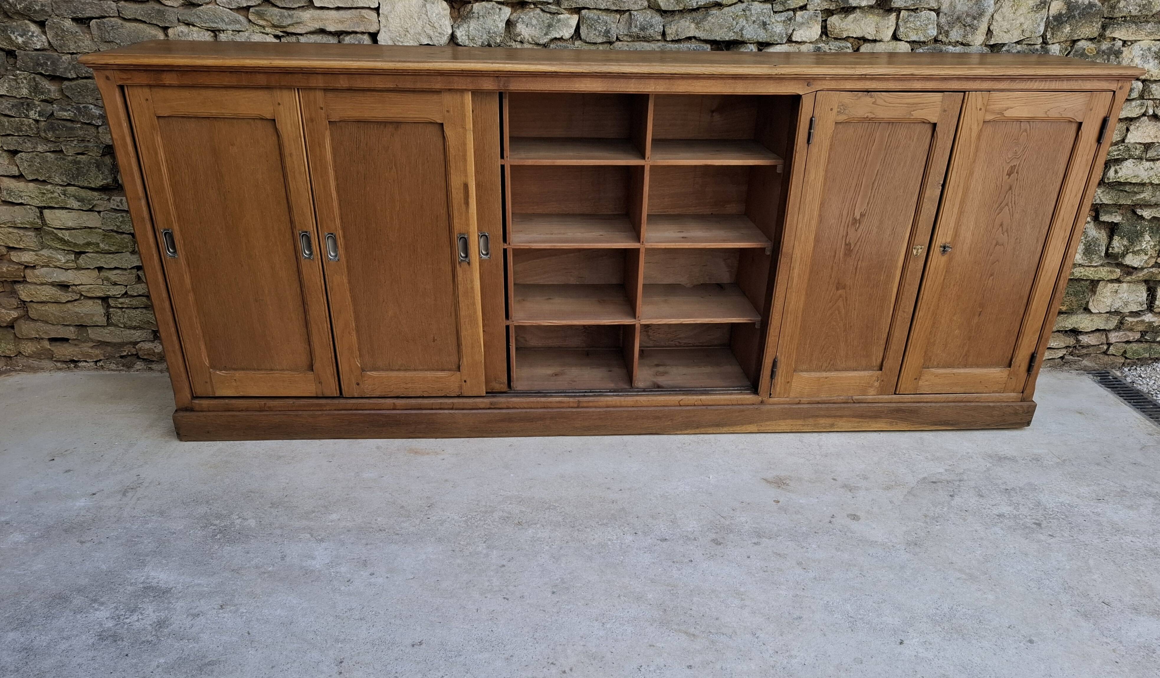 Oak workshop furniture with sliding doors.