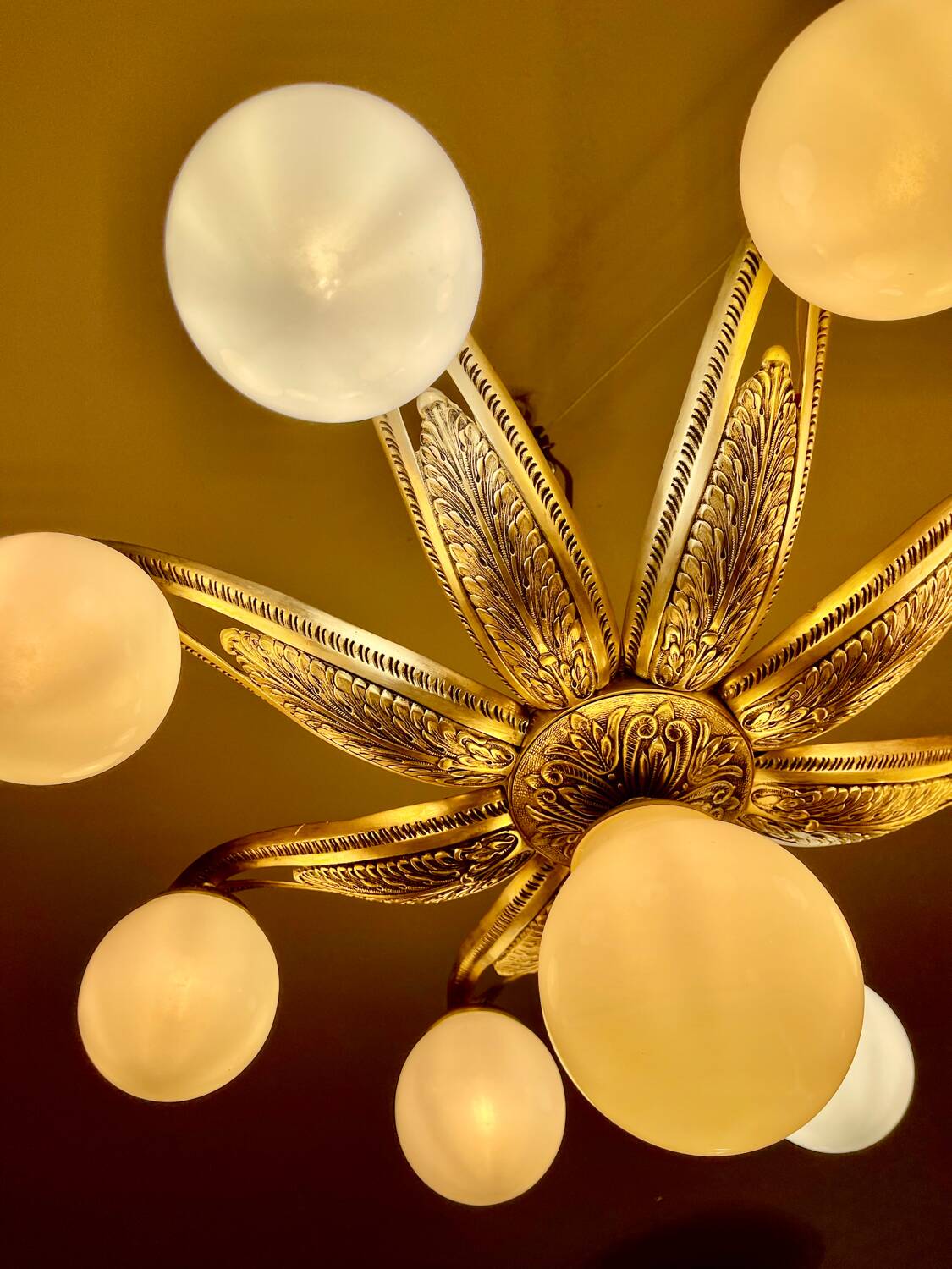 Large Art Deco bronze chandelier with 9 opaline globes, France 1935.