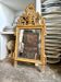 Wood and gilded stucco mirror with a pediment, 85.5 x 45 cm.