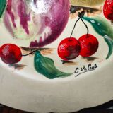 Faience plate in Longwy enamels signed Léa Valenti representing Fruits