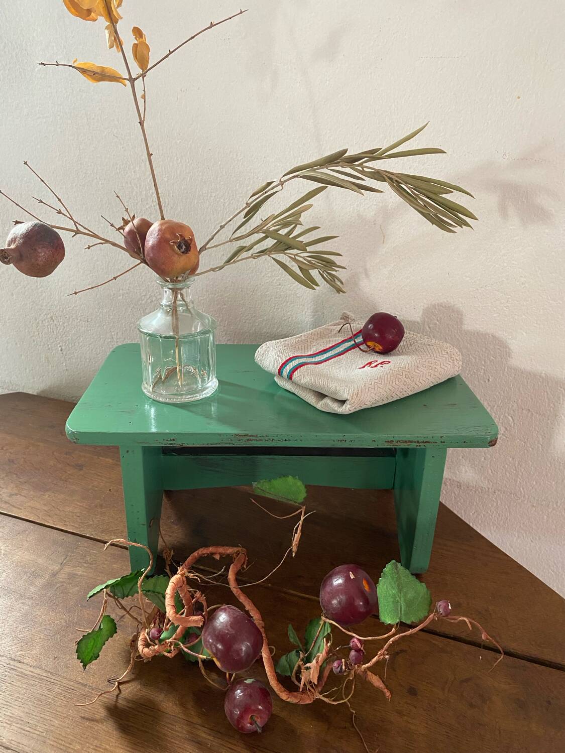 Vintage wooden footrest in mint green.
