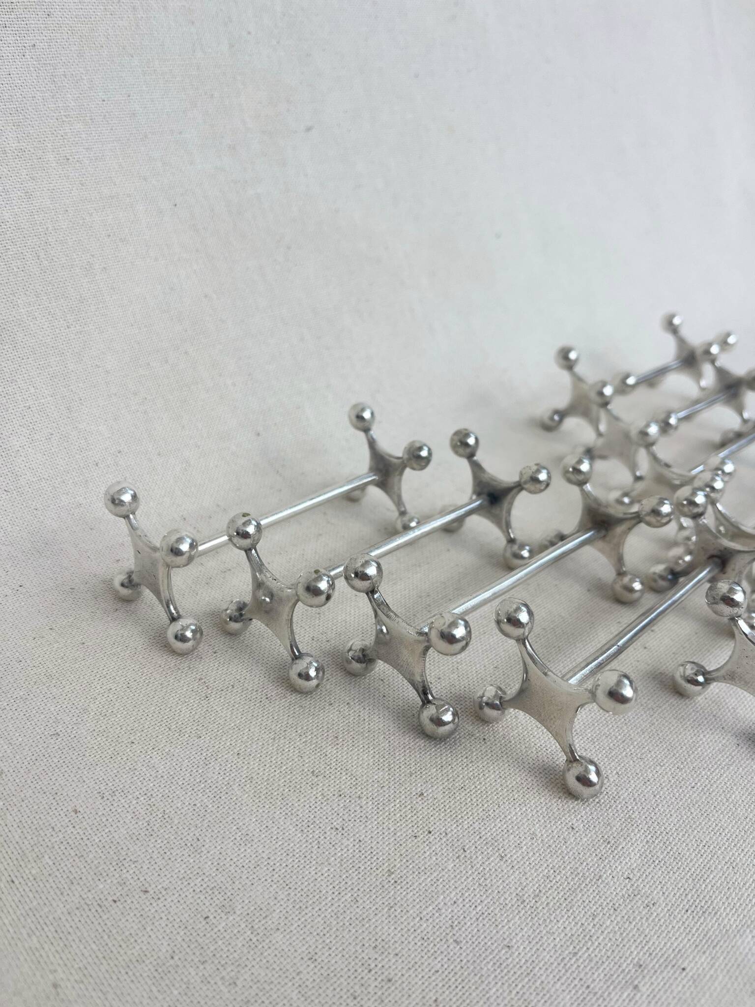 series of brutalist and sculptural silver-plated knife rests