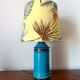 Blue ceramic lamp with claw feet and foliage lampshade.