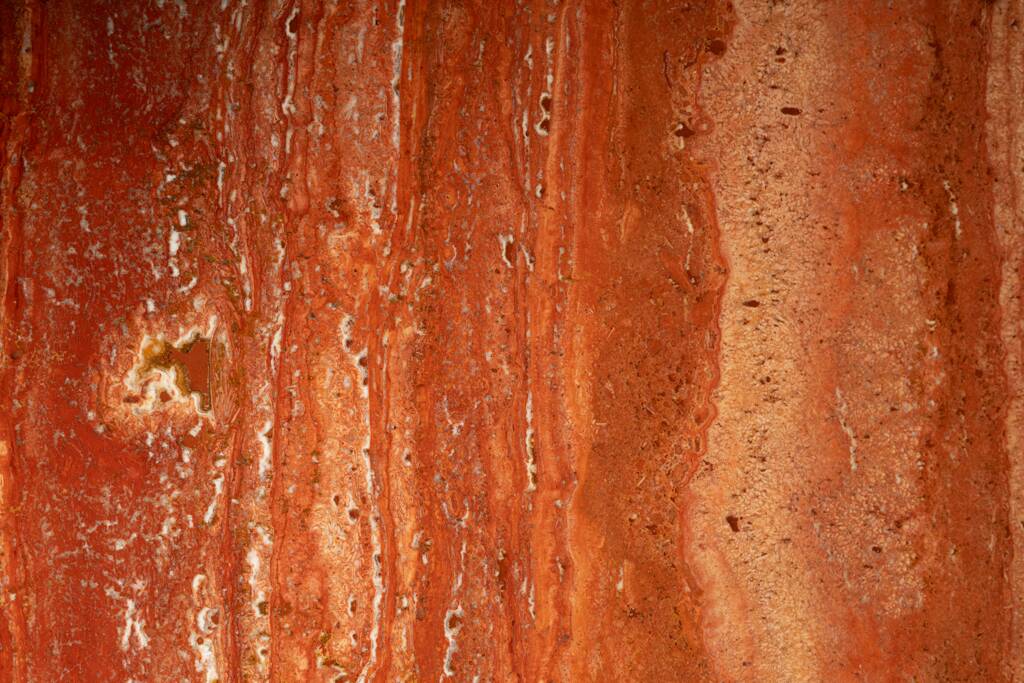 Willy Rizzo. Large table in orange-red travertine. 1970s.