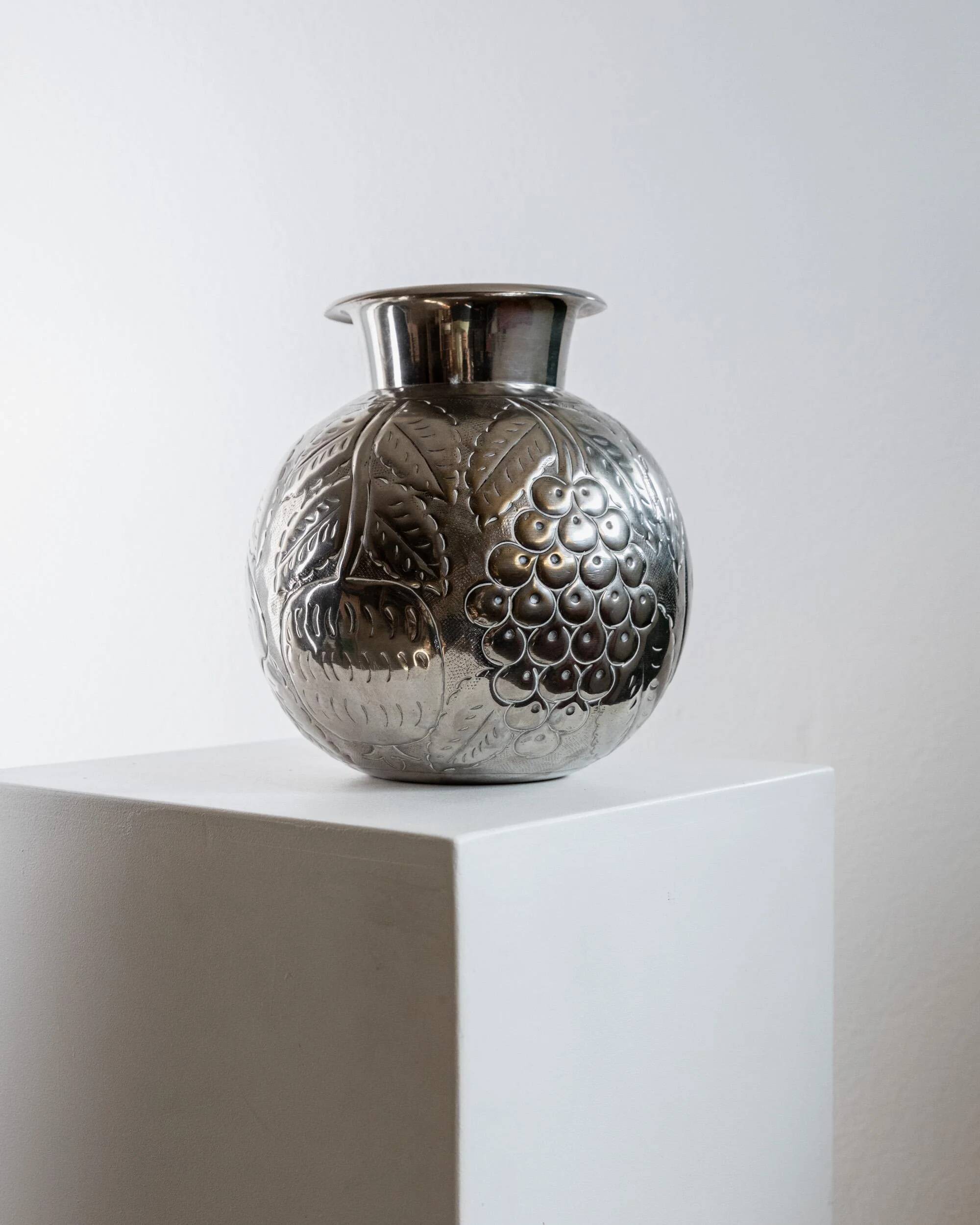 Vintage Italian vase in nickel-plated brass from the 1960s, hand-hammered relief of fruits and leaves.