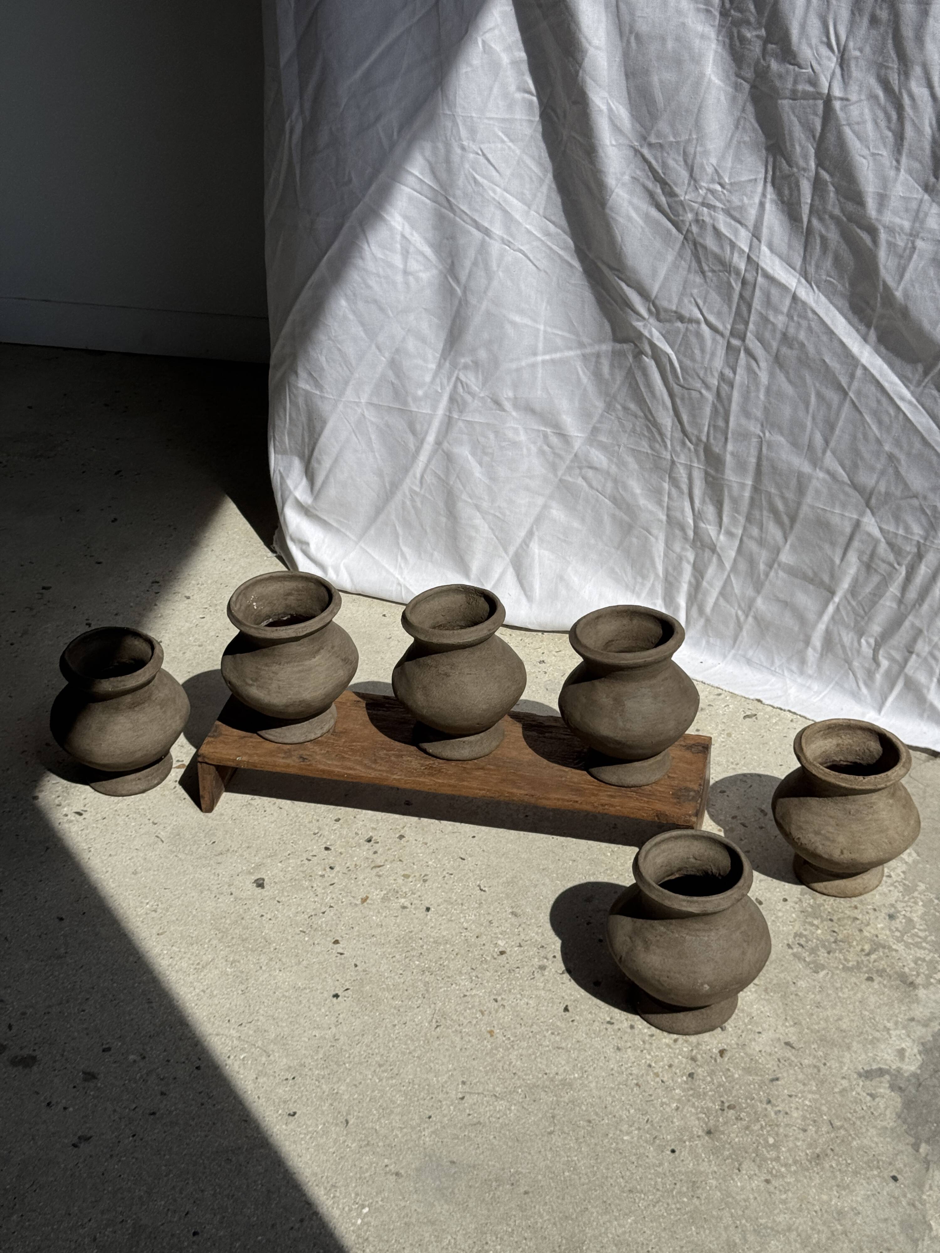 Small brutalist handcrafted terracotta vase with a pedestal, Indonesian, H19 D17.