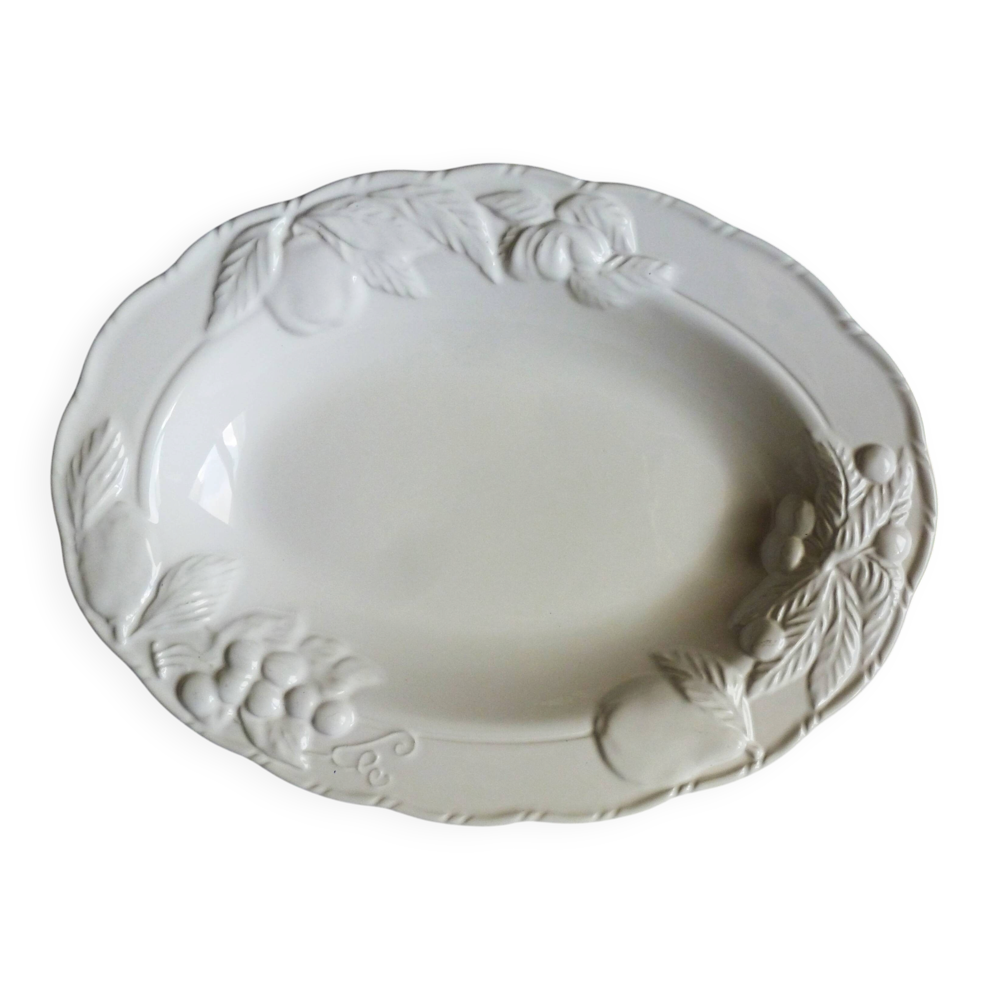 Oval white vegetable dish, an antique tableware piece in barbotine earthenware.