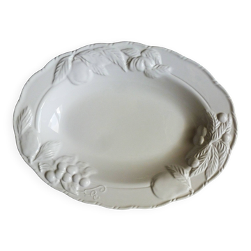Oval white vegetable dish, an antique tableware piece in barbotine earthenware.