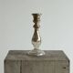 Antique mercury glass candlestick with a patina and silver finish.