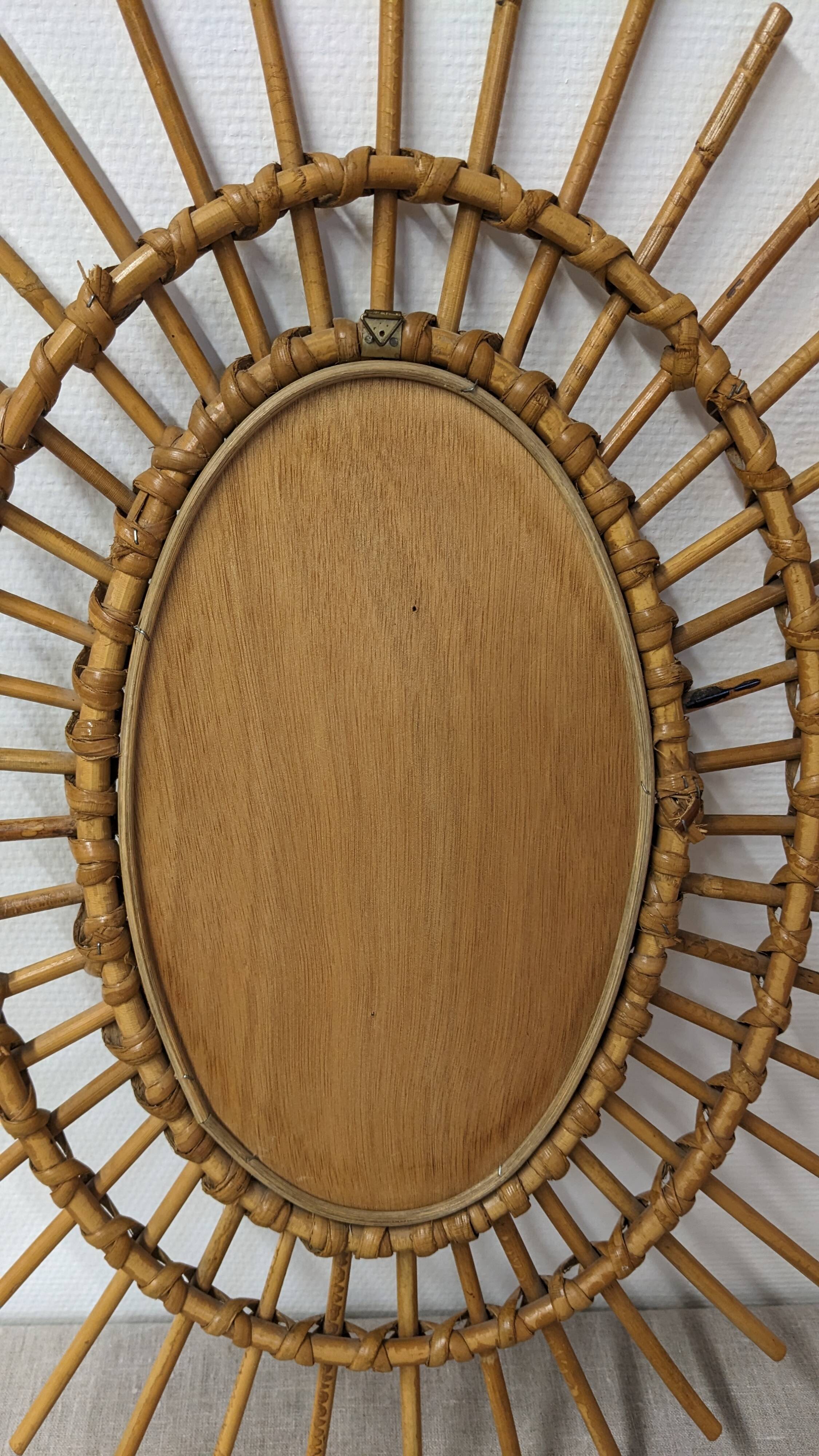 Oval rattan mirror, France circa 1960.