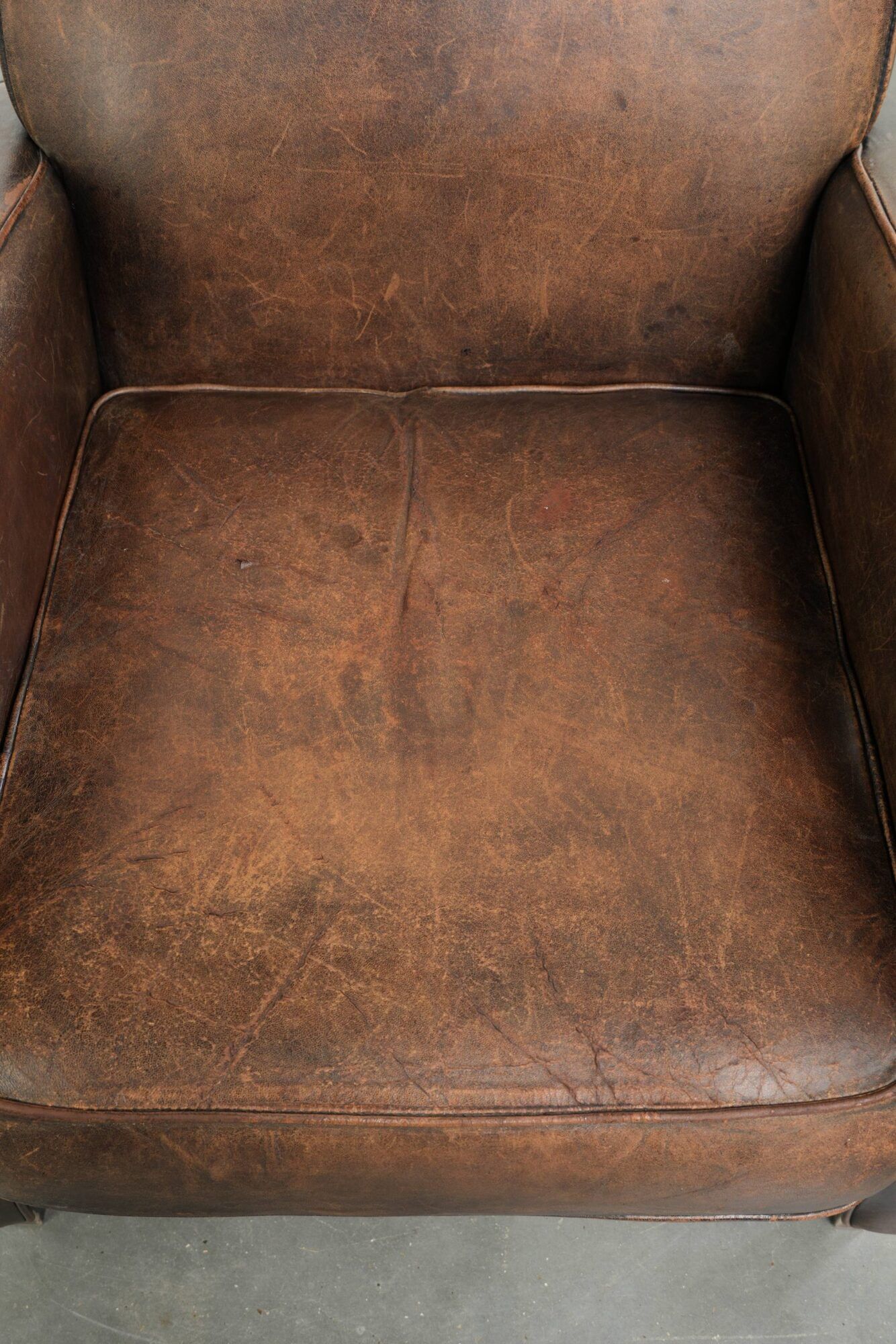 Comfortable sheepskin armchair with matching piping and a timeless look