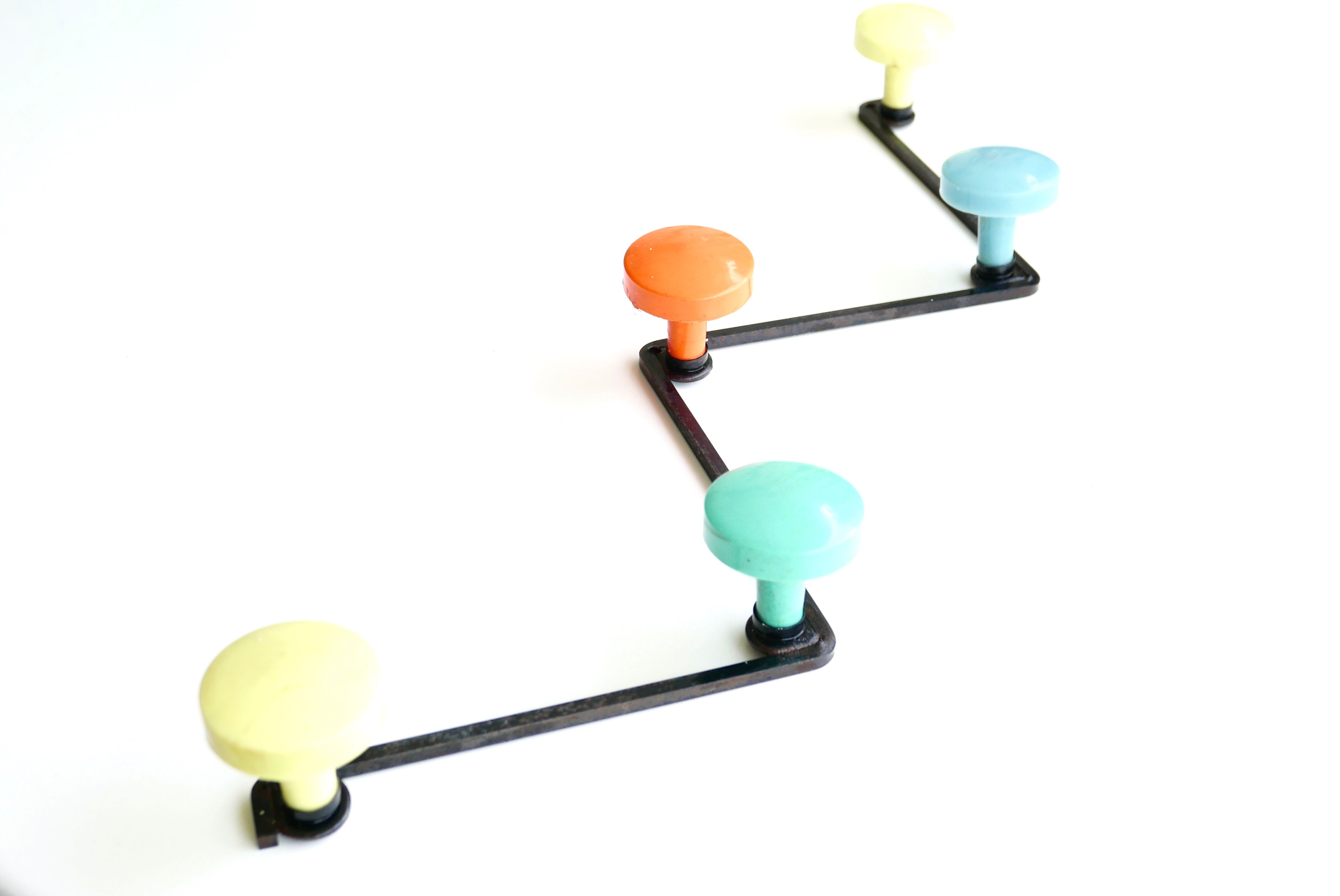 Old coat rack with 50s colored coat hooks