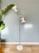 Chrome and white metal floor lamp, circa 1970.