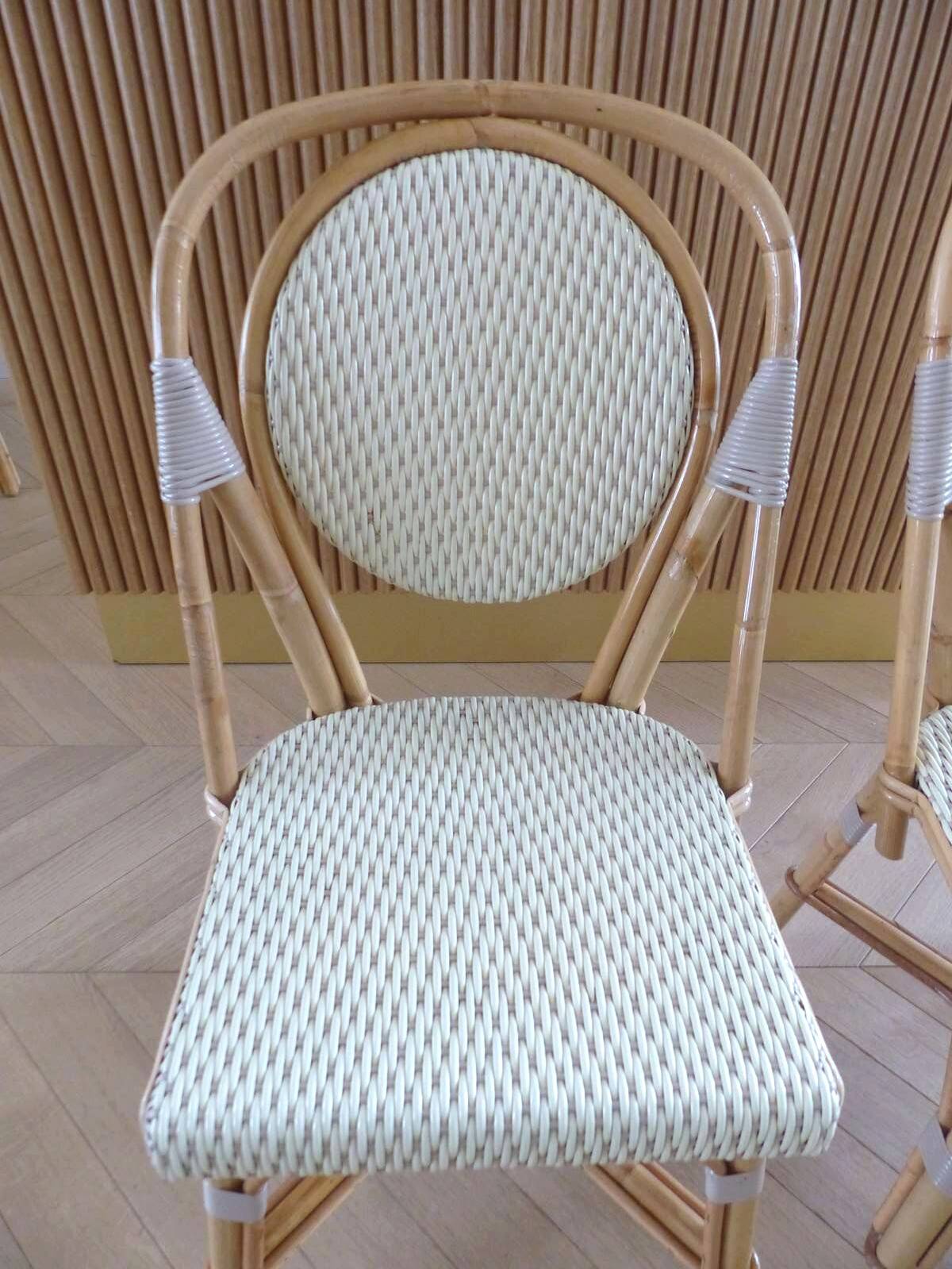 Pair of Parisian bistro chairs from Maison Louis Drucker in light Manila rattan.