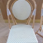 Pair of Parisian bistro chairs from Maison Louis Drucker in light Manila rattan.