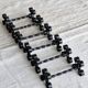 6 vintage black metal knife rests with scrollwork decoration