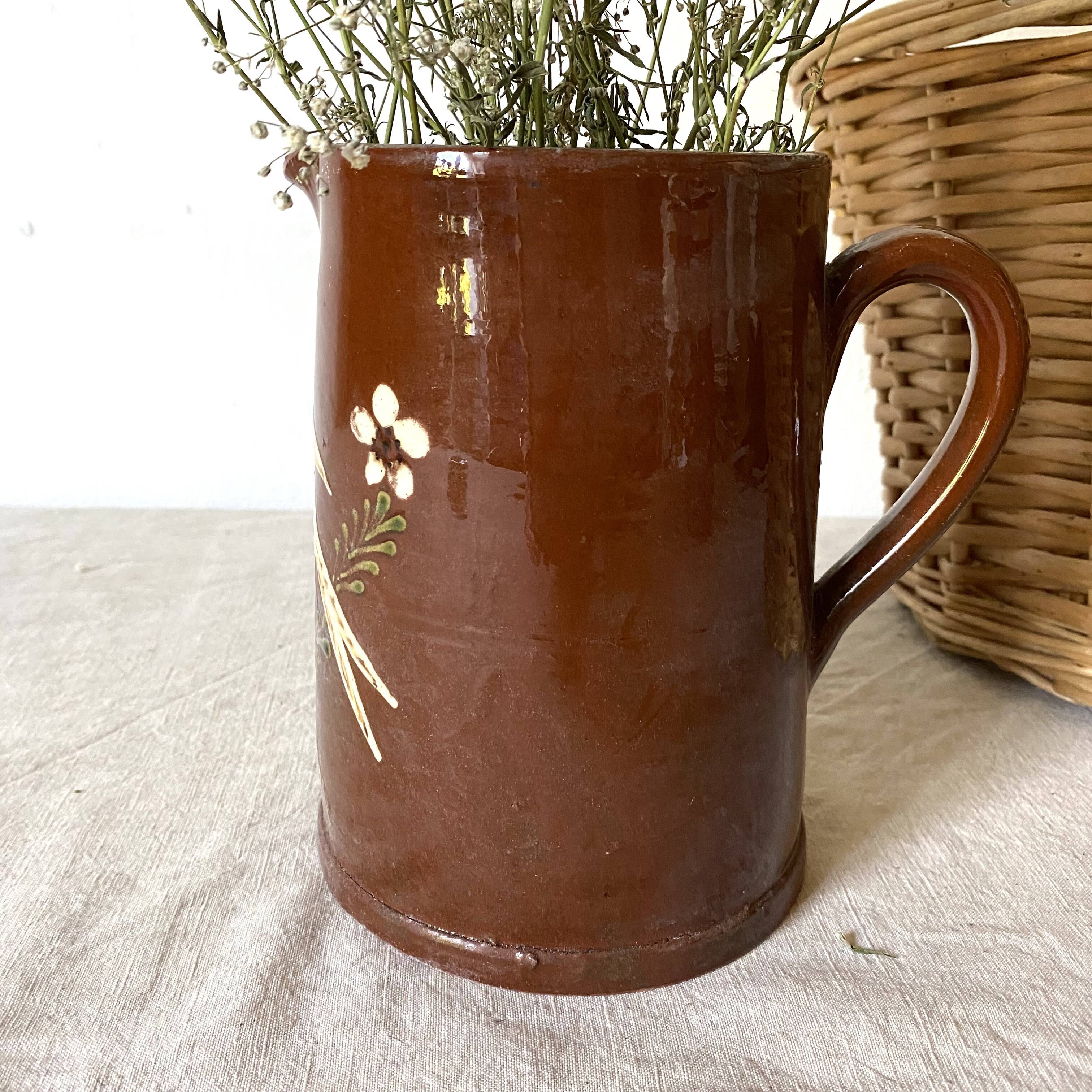 Terracotta pitcher with hand-painted bird decor