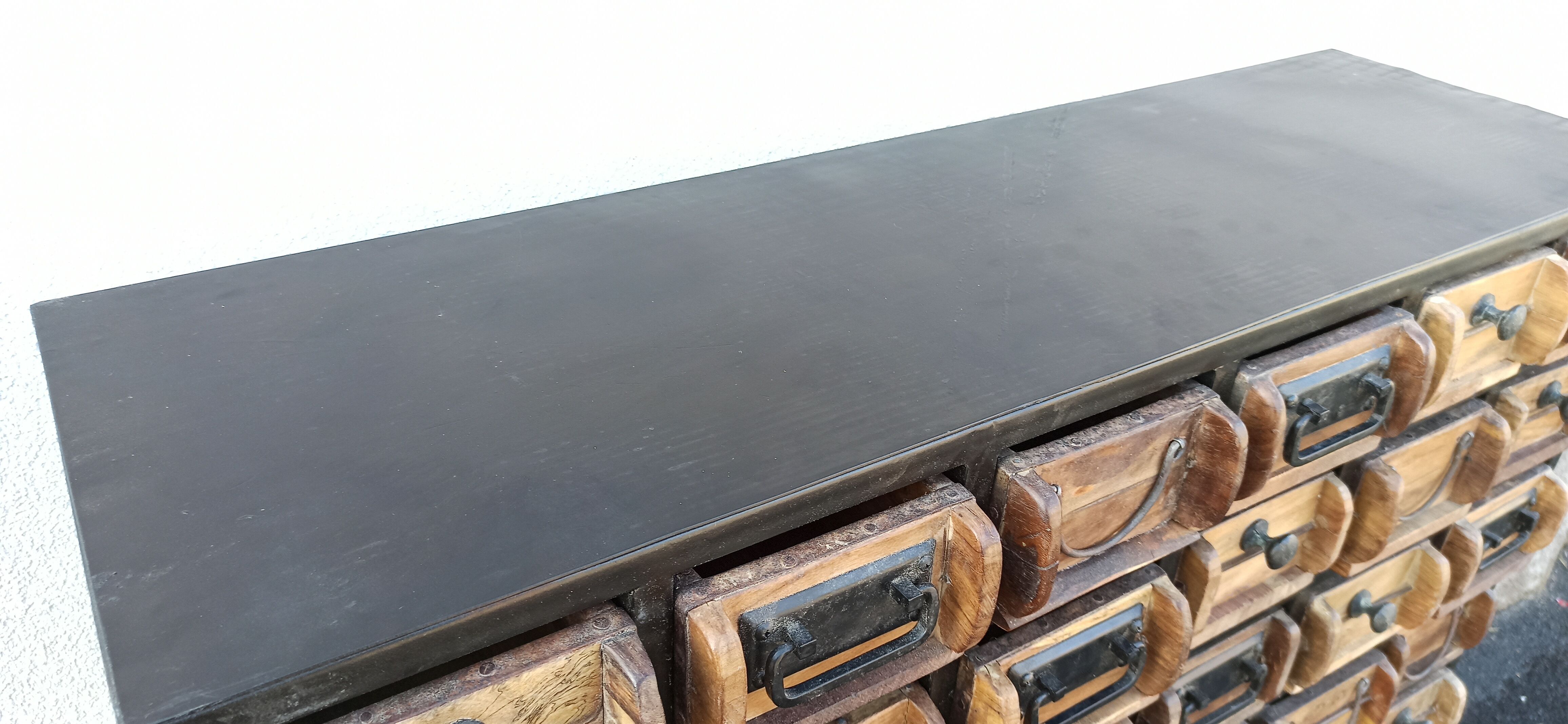 Black metal storage cabinet with 60 wooden drawers