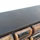 Black metal storage cabinet with 60 wooden drawers
