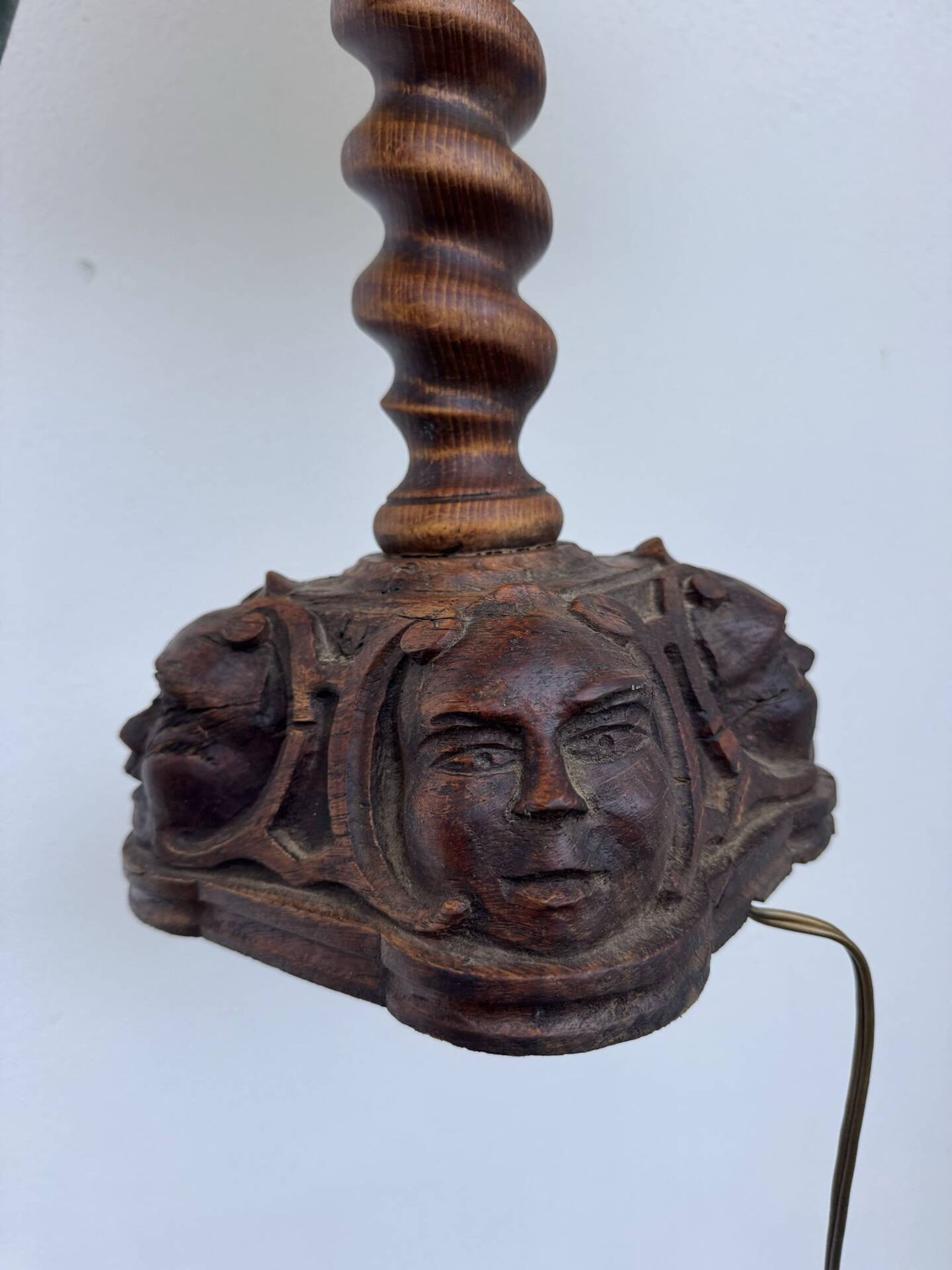 Sculpted wooden lamp with faces, antique.