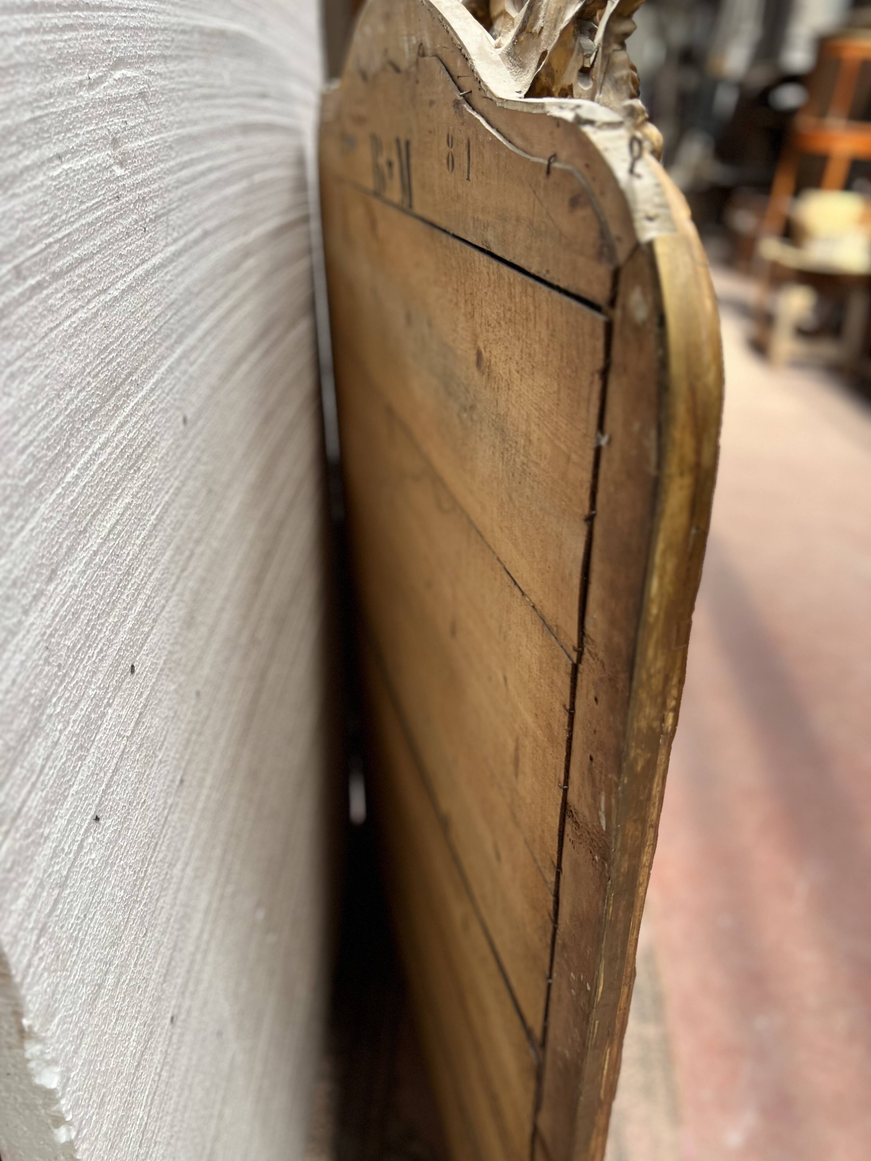 Louis XV style mirror in gilded wood and stucco, 20th century.