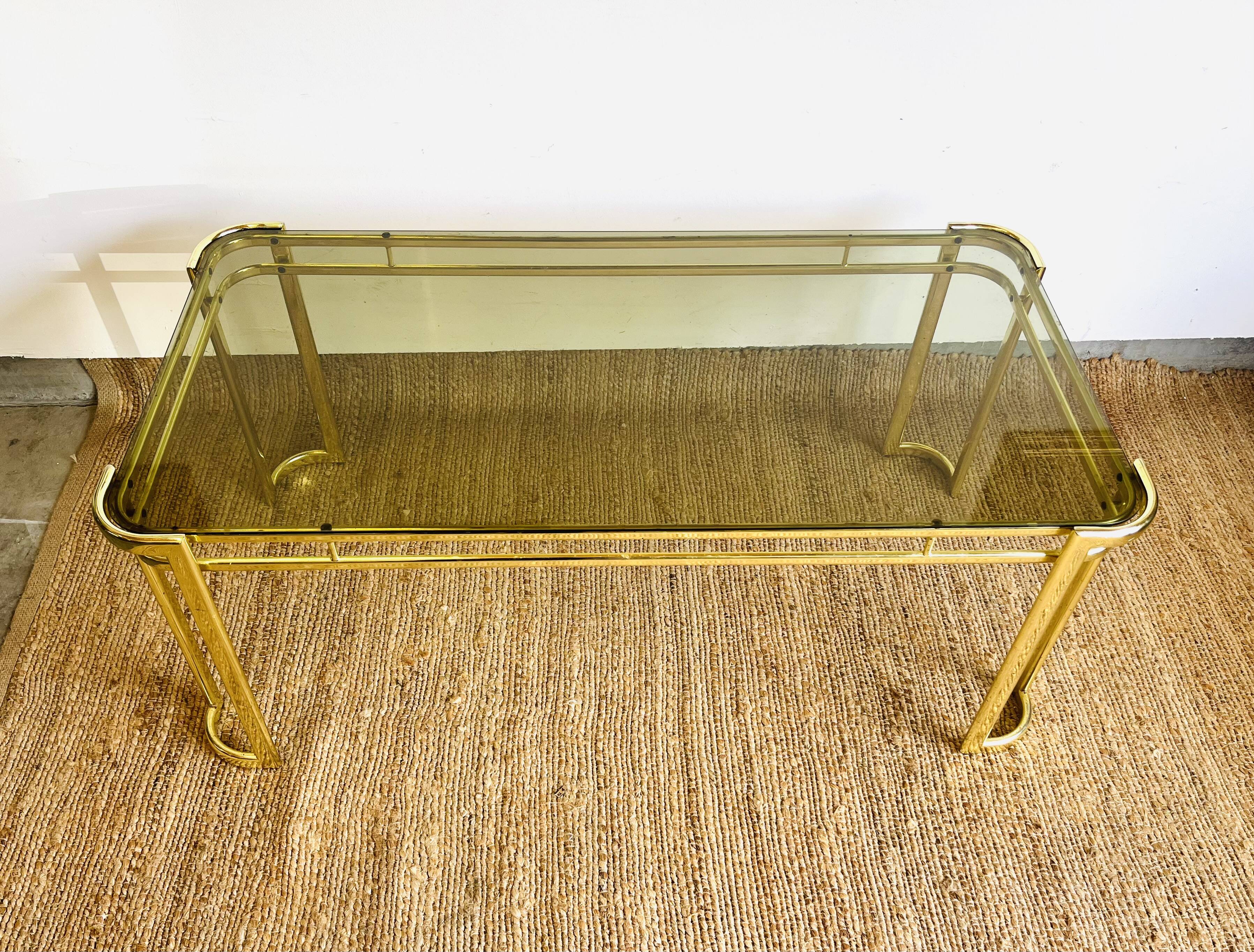 Gold metal and smoked glass coffee table – 1970s-624001