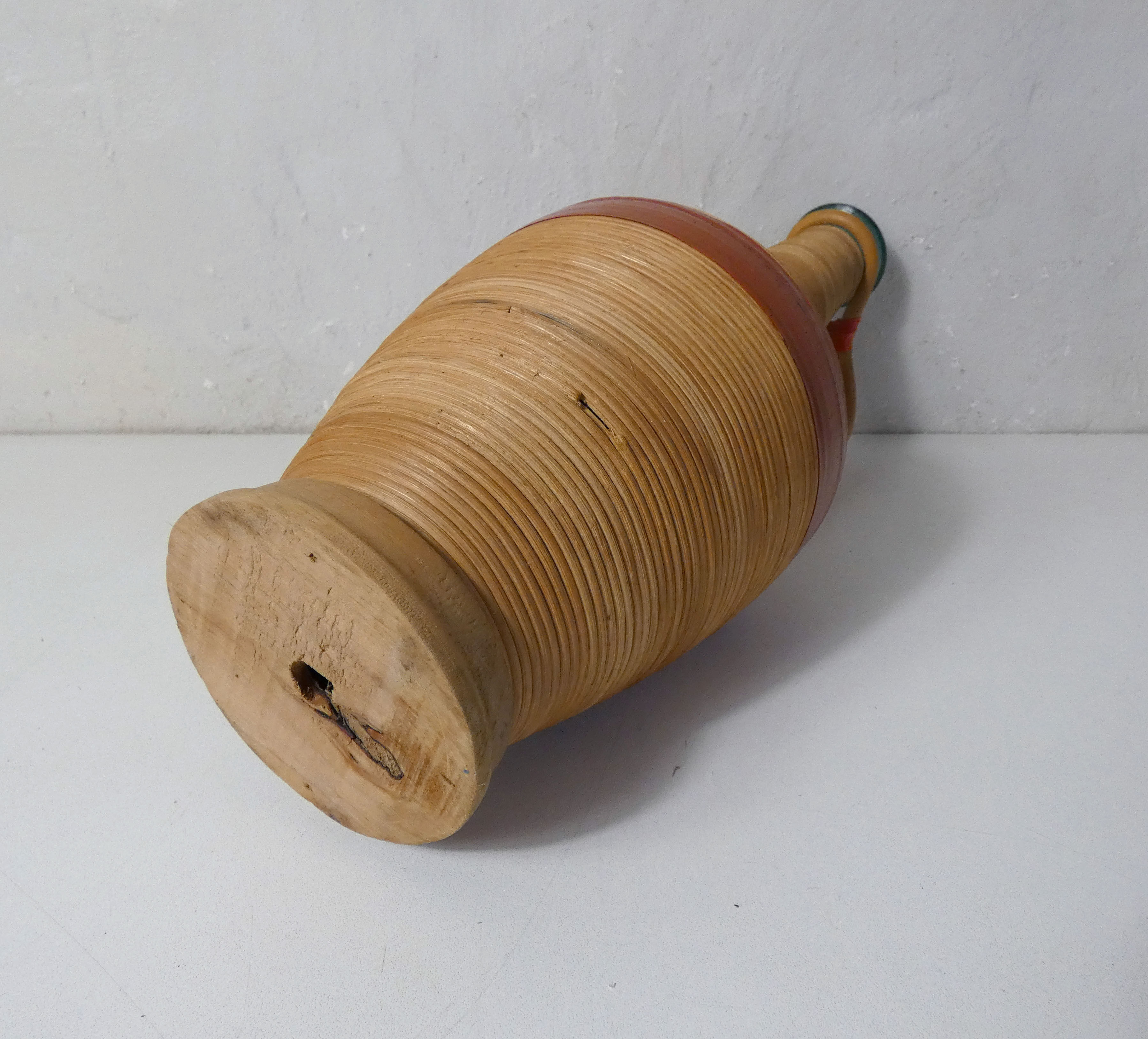 Old bottle dressed in vintage wood rattan