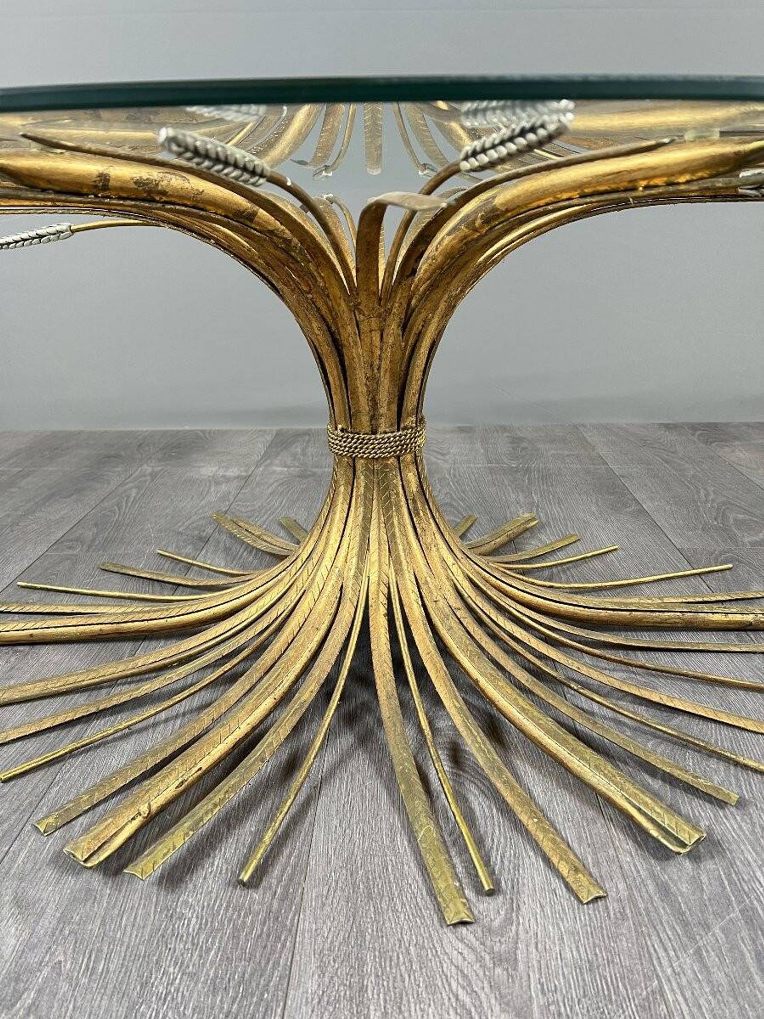Gold metal and glass coffee table, 20th century, in the style of Robert Goos.