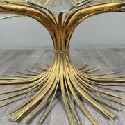 Gold metal and glass coffee table, 20th century, in the style of Robert Goos.