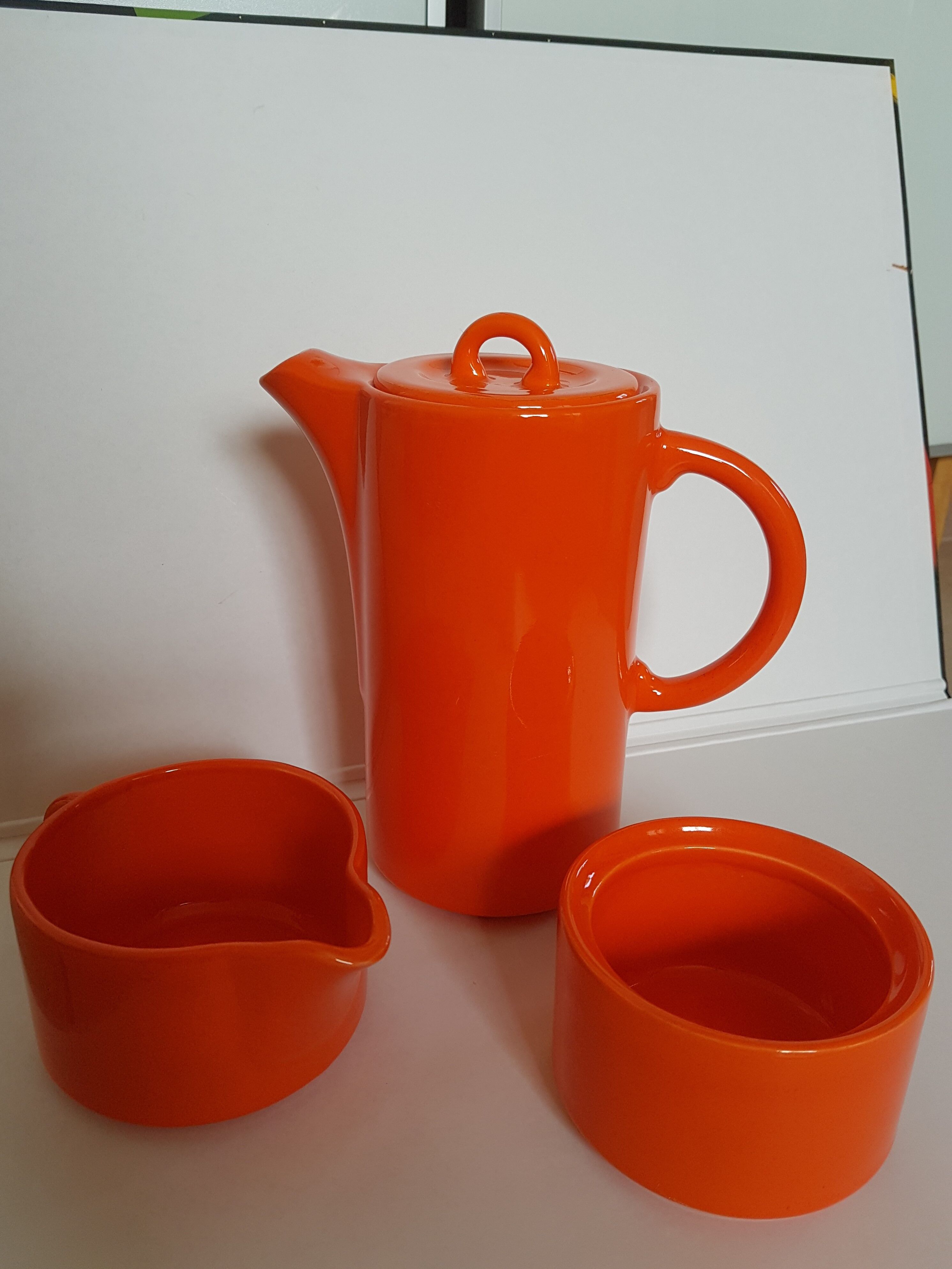 Coffee pot has orange 1970 sugar milk