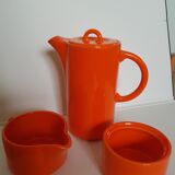 Coffee pot has orange 1970 sugar milk