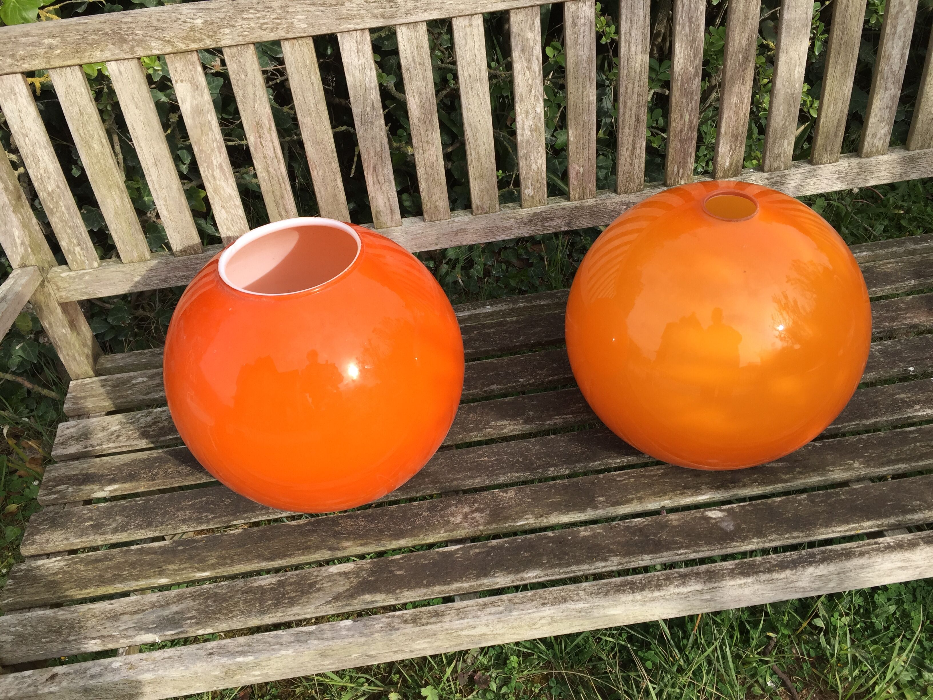 Two orange opaline globes, 30 cm diameter