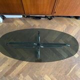 70s design oval coffee table in smoked black glass with chrome legs.